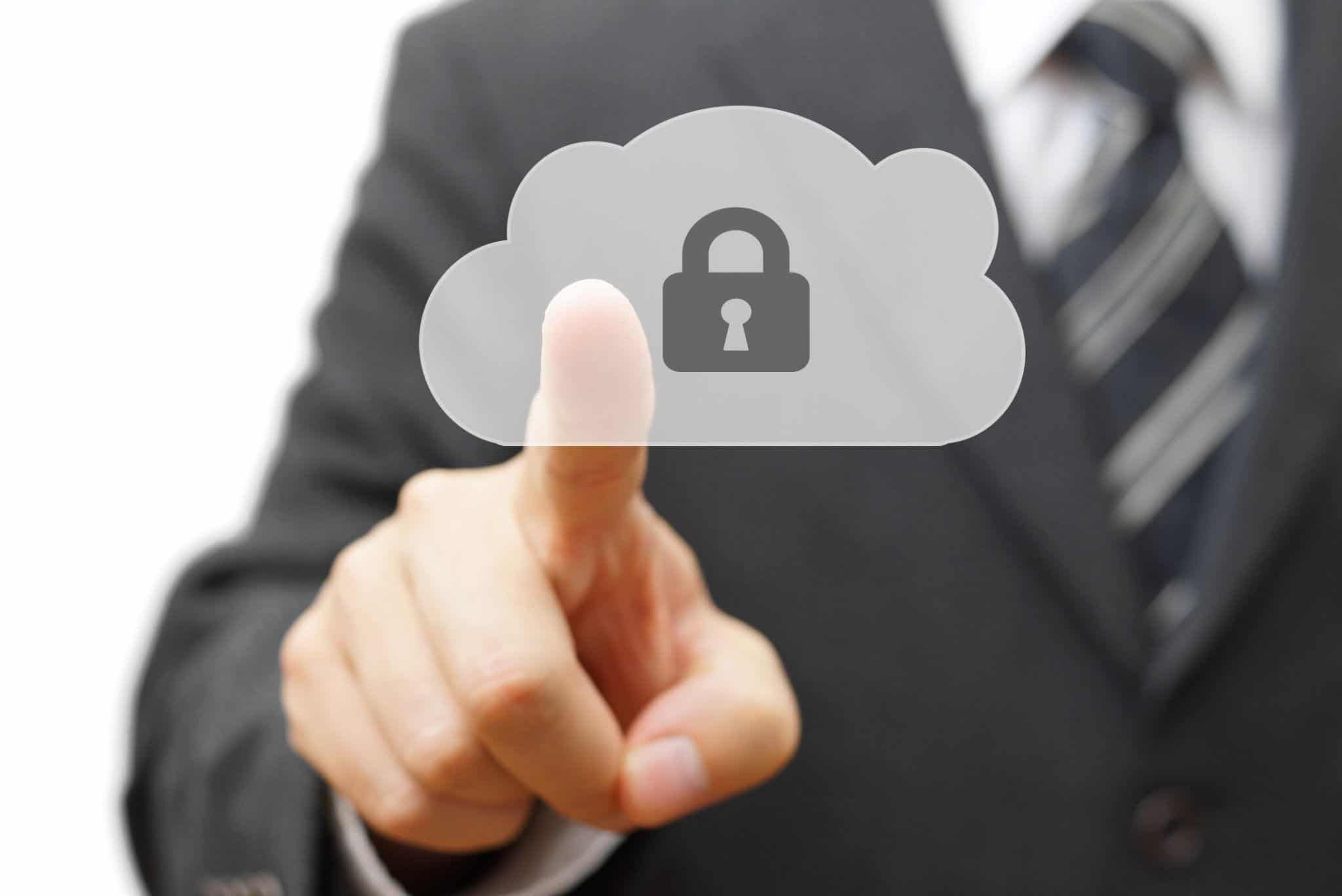 A businessman touches a cloud with a lock, symbolizing cybersecurity.
