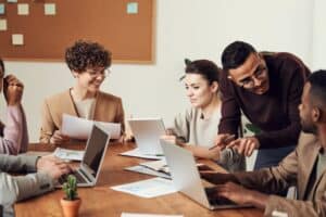 A group of employees meet to discuss the latest cybersecurity processes for their business.