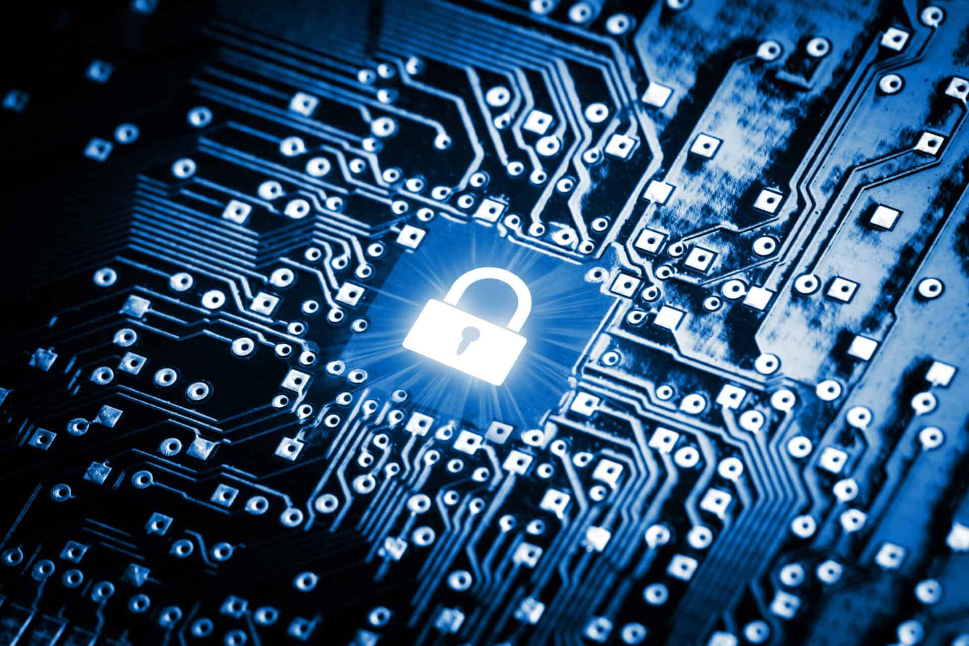 A glowing lock on a motherboard chip symbolizes cybersecurity.