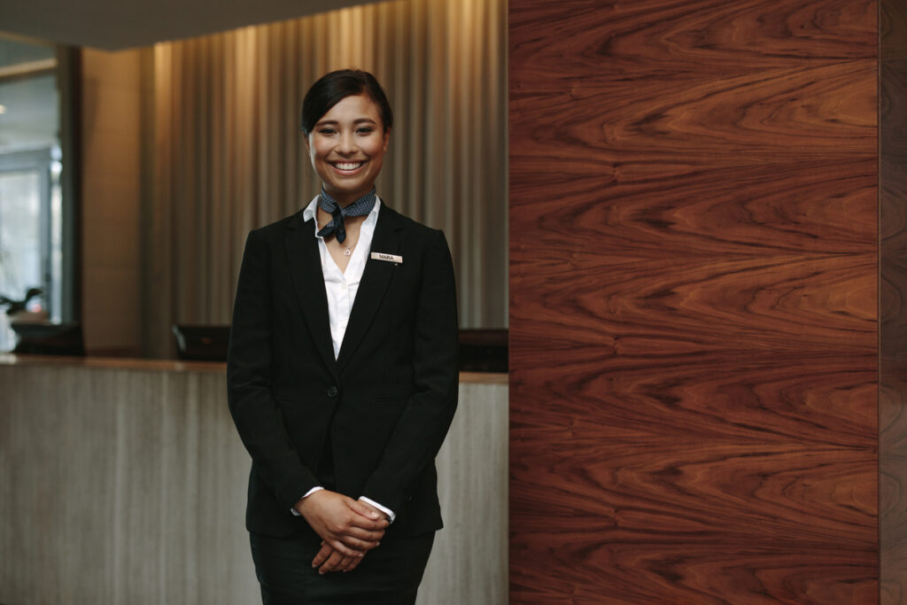 hospitality employee standing near front desk