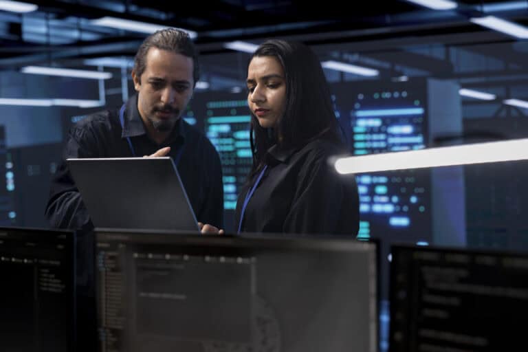 coworkers in data center doing routine disk checks