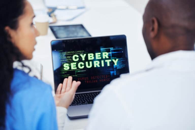 woman and man in front of laptop with cyber security problem