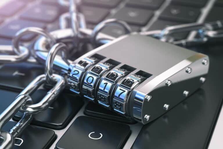 Combination padlock on laptop keyboard symbolizing data protection