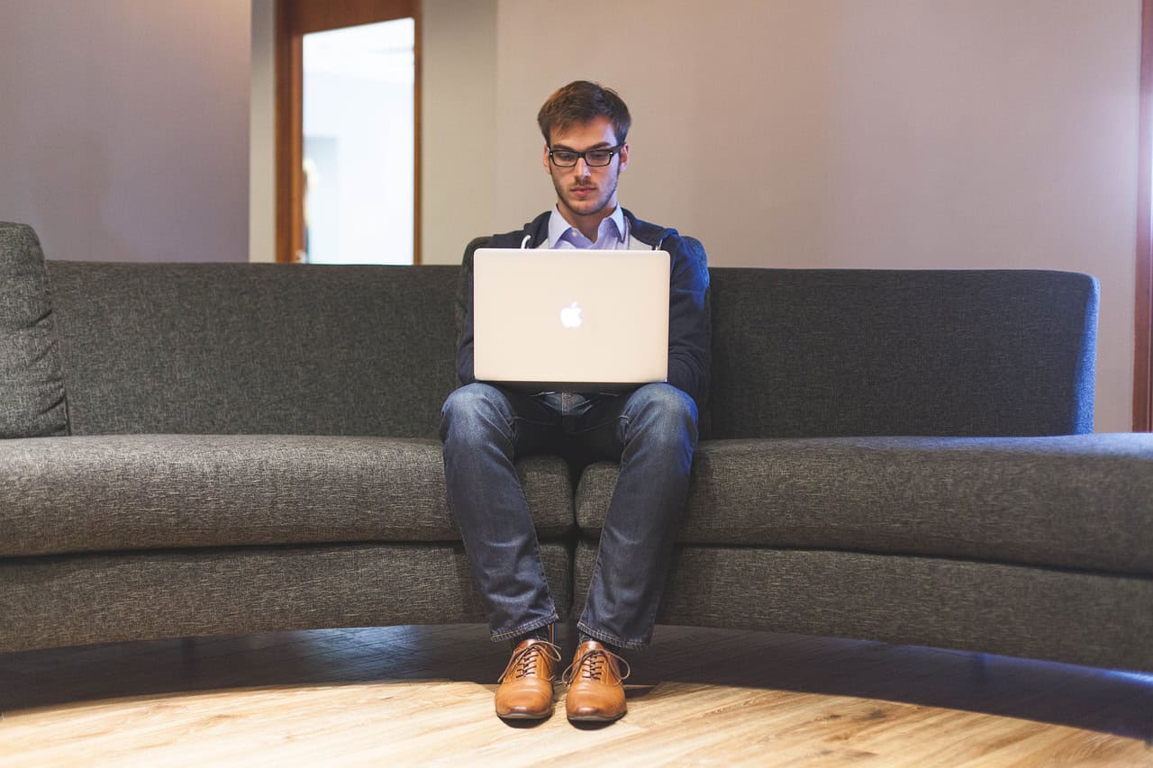 A man works on his Macbook.