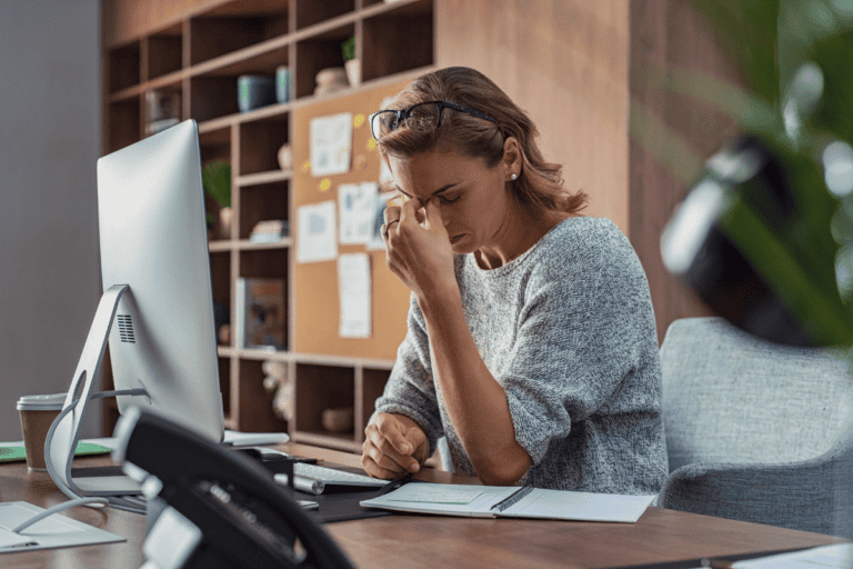 Business woman having headache at office stock photo