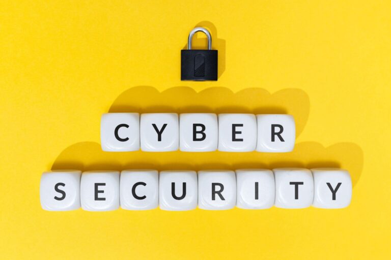 White blocks spelling Cyber Security with a padlock on yellow background