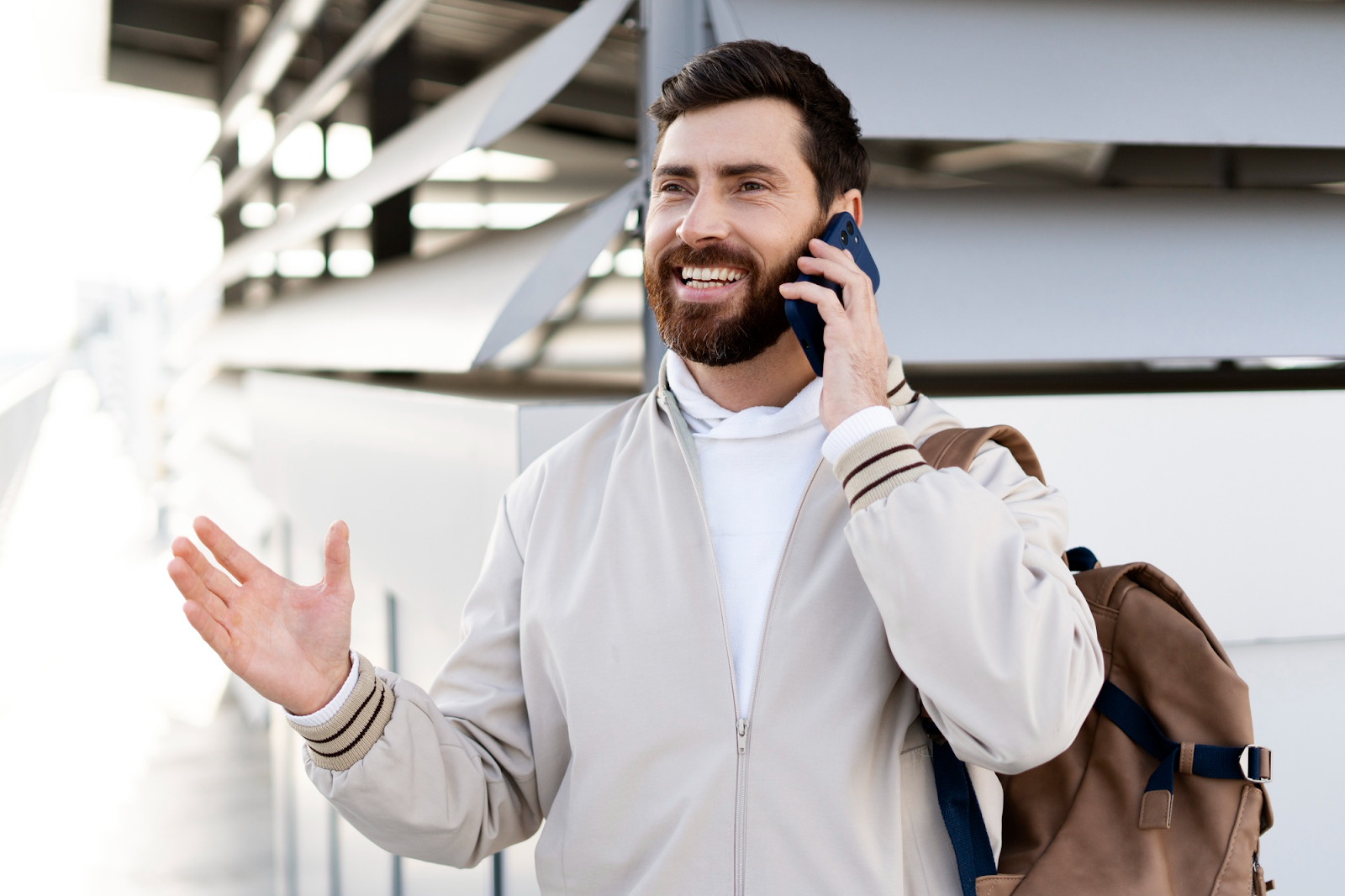A smiling man talking on a mobile phone