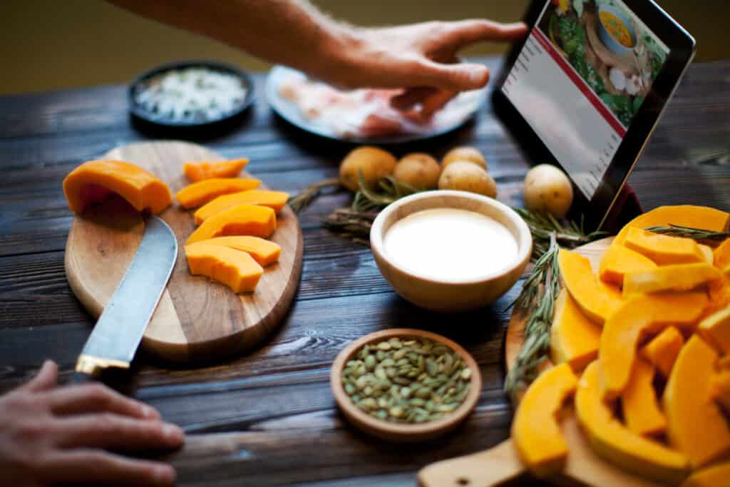 Cooking pumpkin soup with the assistance of a smart tablet.