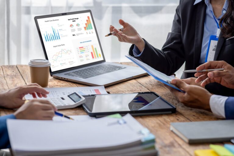 healthcare-business-professionals-reviewing-charts-laptop