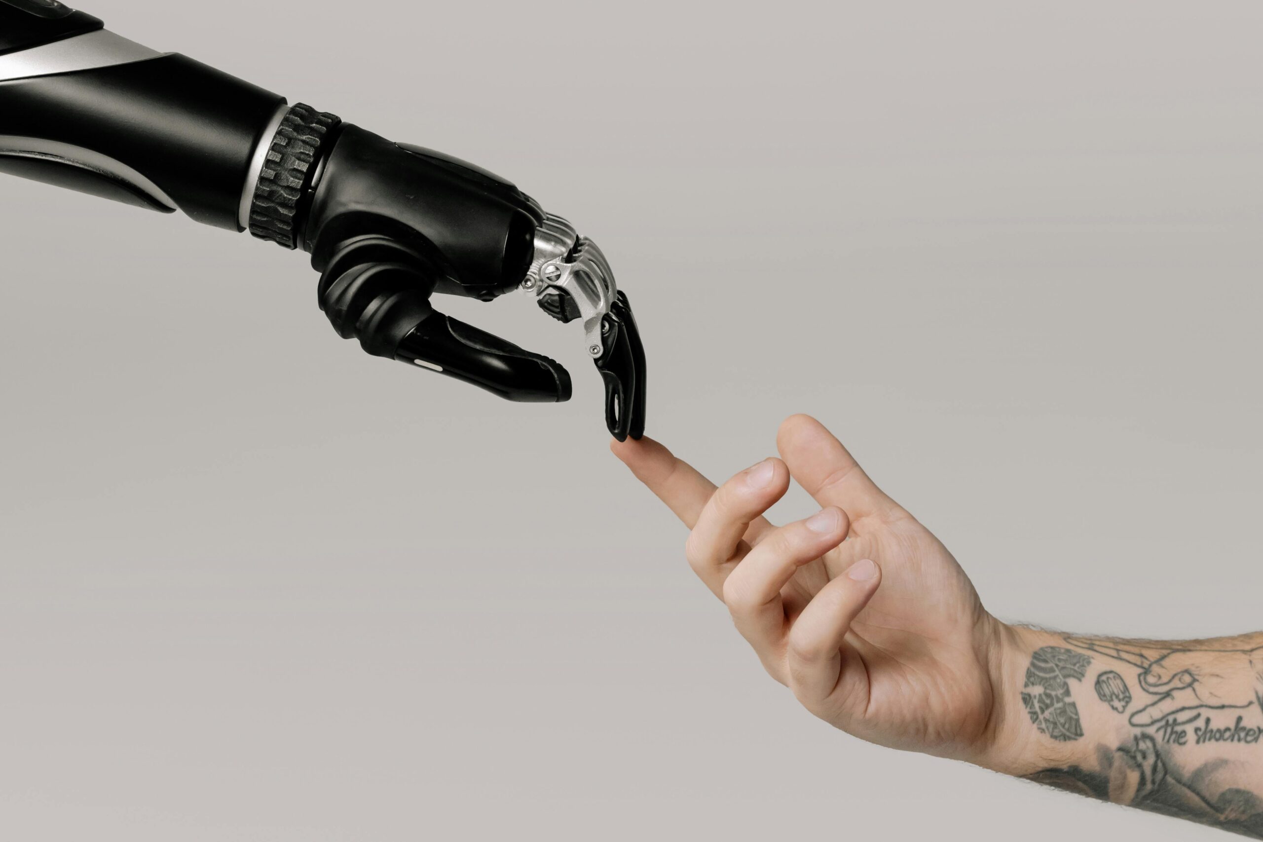 A robot hand and a human hand touching
