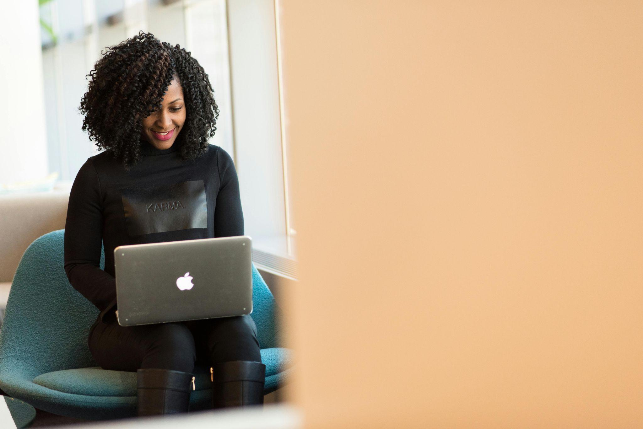 A woman working on her laptop in the office.