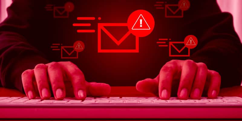 Many red warning alerts with envelope icon on computer screen describes email threats.