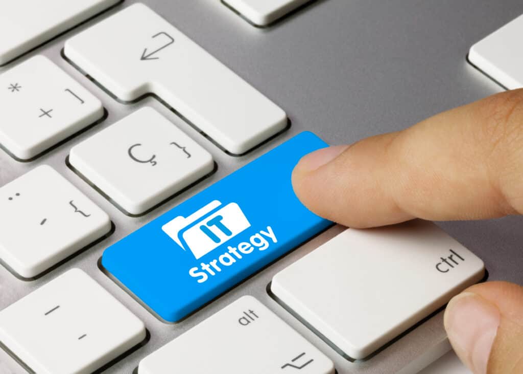 A finger pressing down on a blue keyboard button that says "strategy"