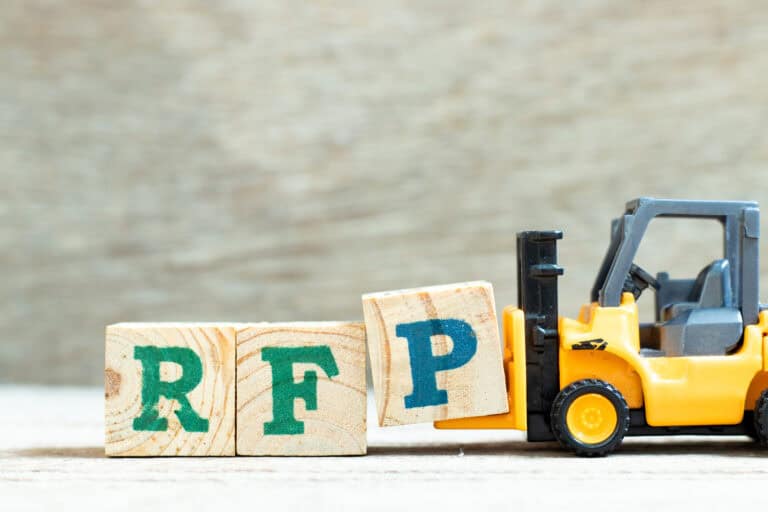 A toy forklift holding wooden letter blocks of R, F and P indicating the abbreviation for request for proposal.