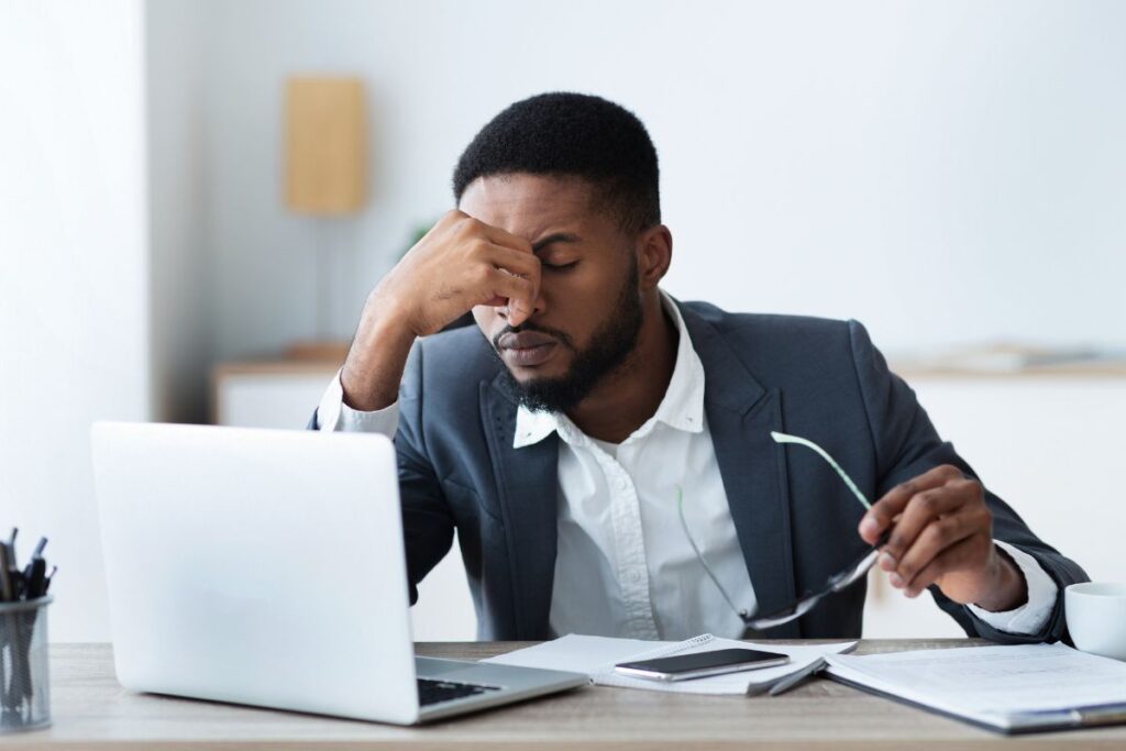 Business owner reviewing IT disaster recovery plan during hurricane season, preparing for storms and protecting company data.