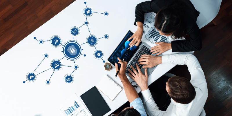 Team of IT experts collaborating on a cybersecurity strategy tailored for small businesses.