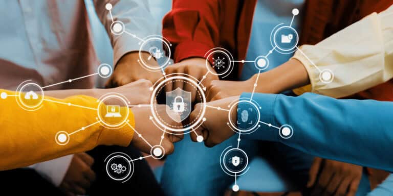 Team hands stacked together in a circle, representing the collective effort of the human element in cybersecurity.