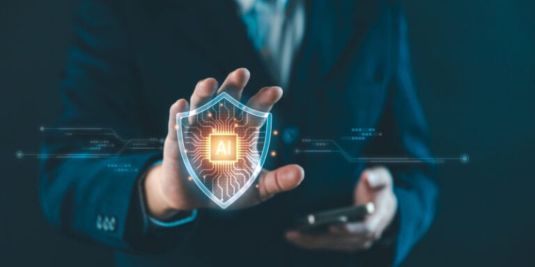 Person holding an AI-labeled shield representing protection and security