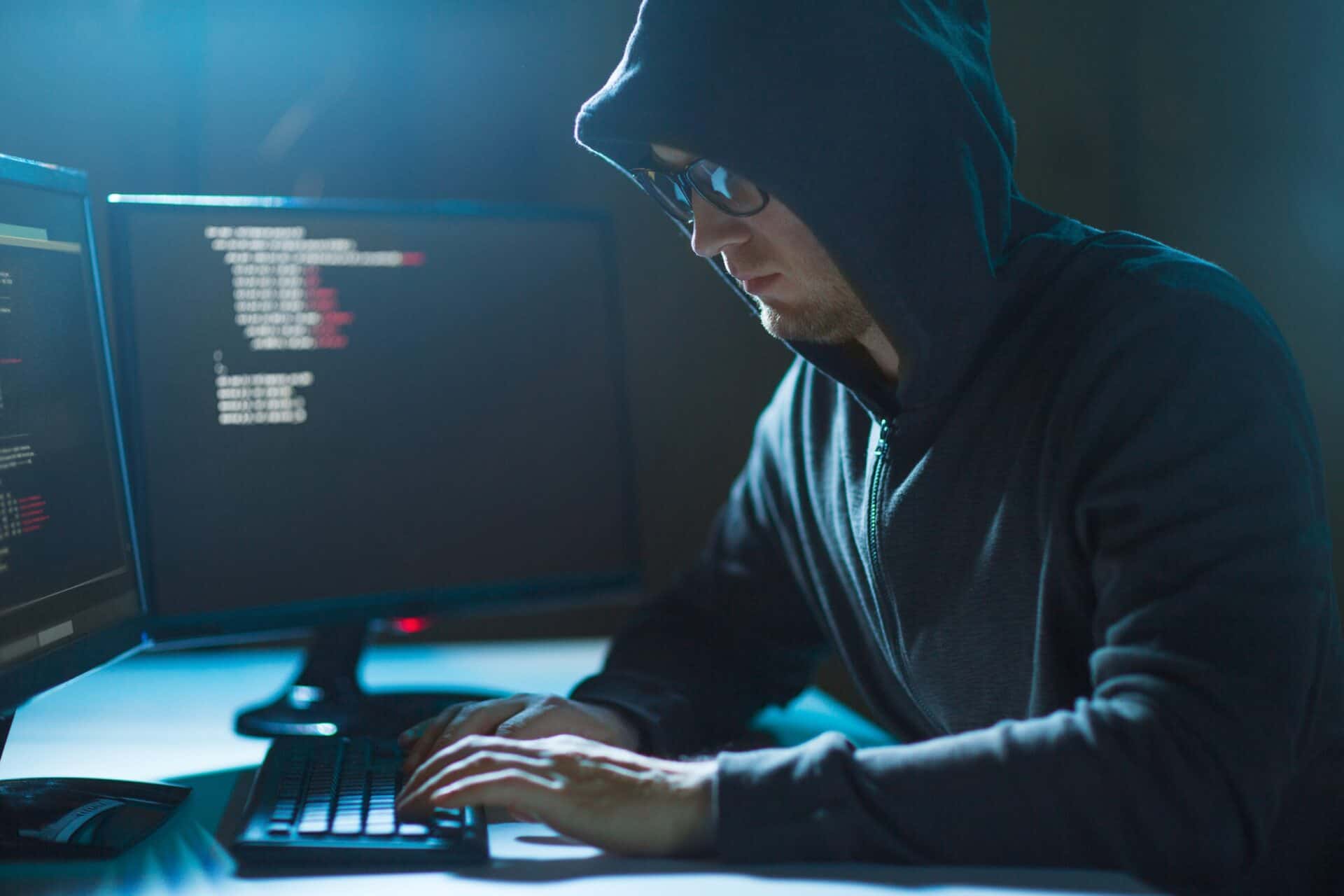 A potential hacker intently works on a computer.