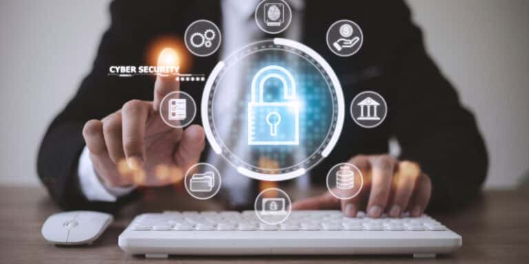 A small business owner uses mobile phone to access a digital portal for enterprise-grade cybersecurity.
