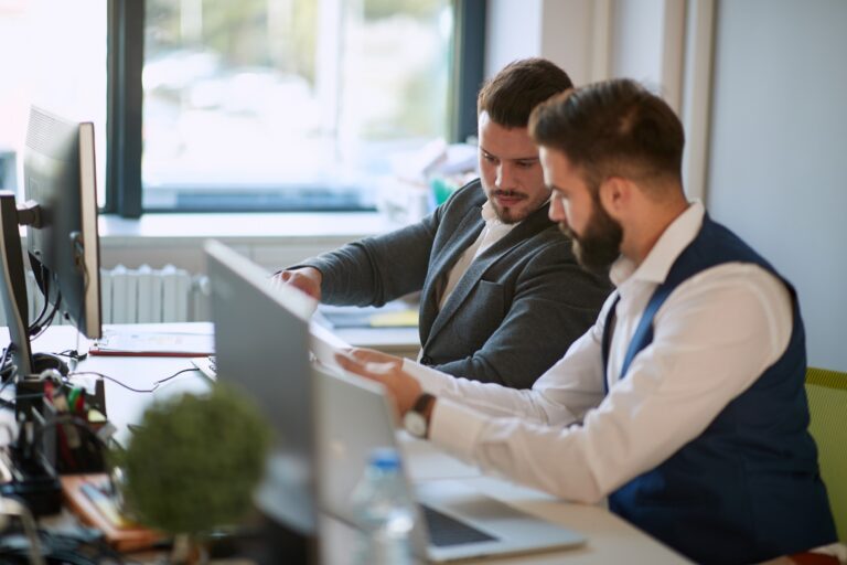 A business owner meets with a cybersecurity specialist to learn new cyber hygiene practices