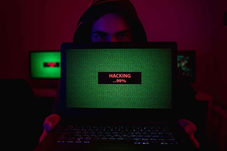 man showing laptop with hacking process