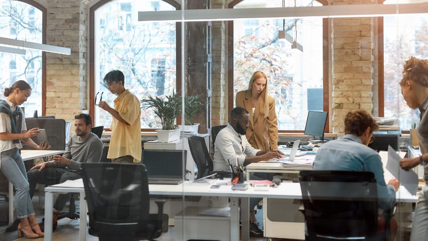 Working together on a project. Group of young mixed-race business people working together in the creative office.