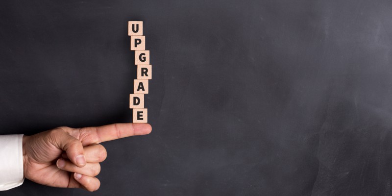 UPGRADE word formed with stacked blocks illustrates when to upgrade the business technology.