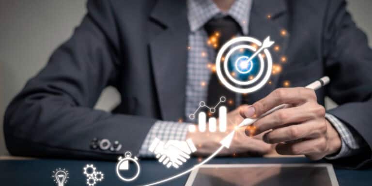 A businessman drawing a digital growth arrow with icons illustrate the outcome of managed IT services.