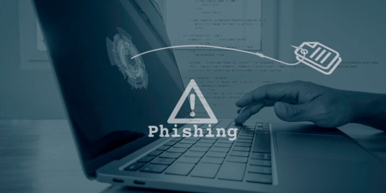 A man working on a laptop and an alert pops up for phishing attack.