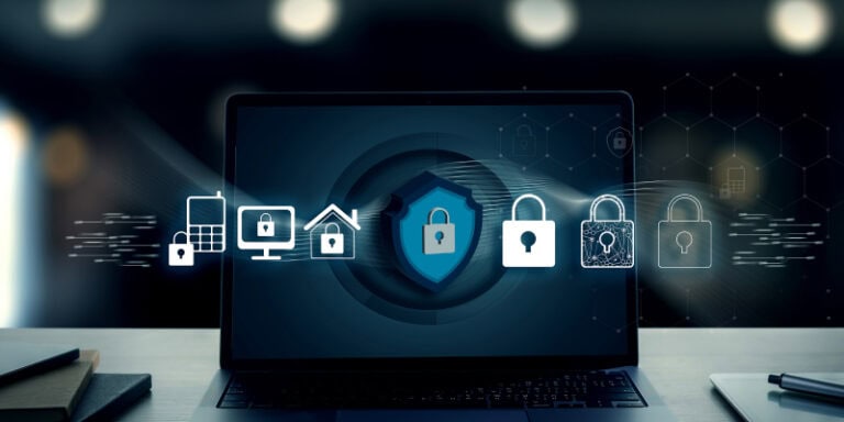Cybersecurity protection concept on laptop screen with digital shield and data network icons, representing cyber insurance requirements and risk protection for SMEs in 2026.
