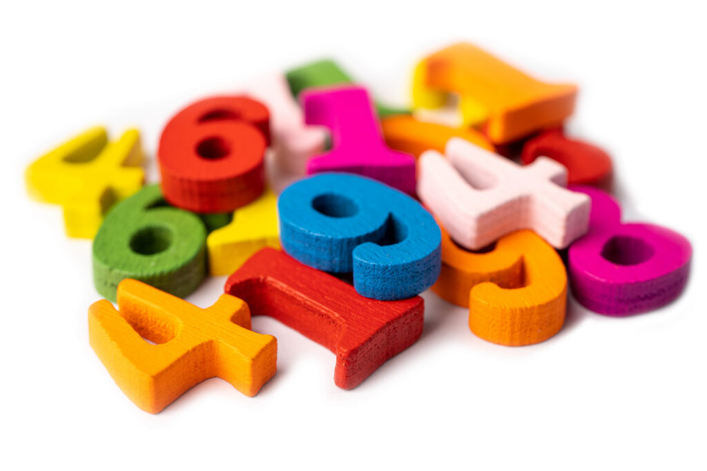 Colorful foam number shapes scattered on a white background.