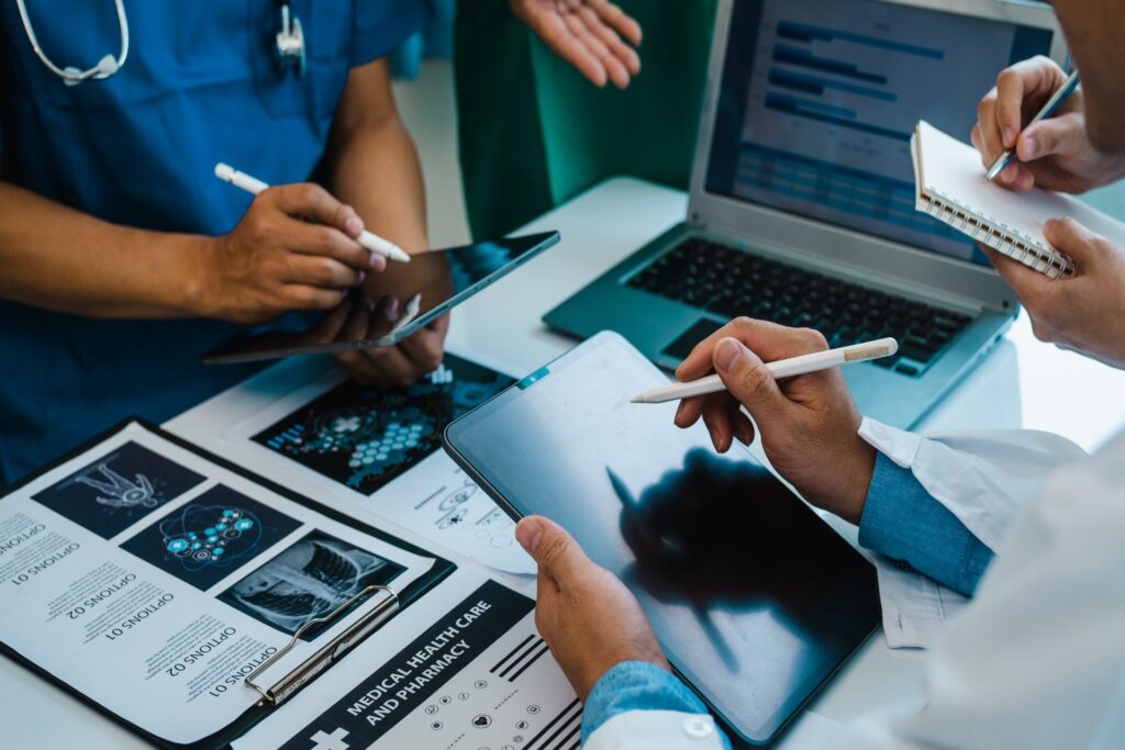 doctors-nurses-reviewing-medical-scans-tablets-hospital