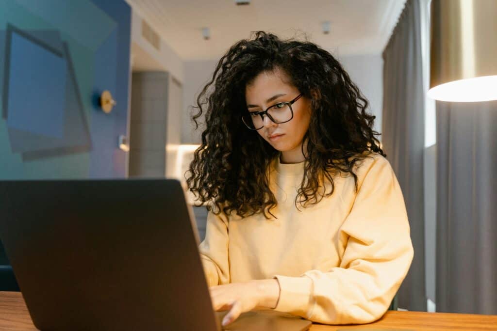 A woman works at home using a laptop.