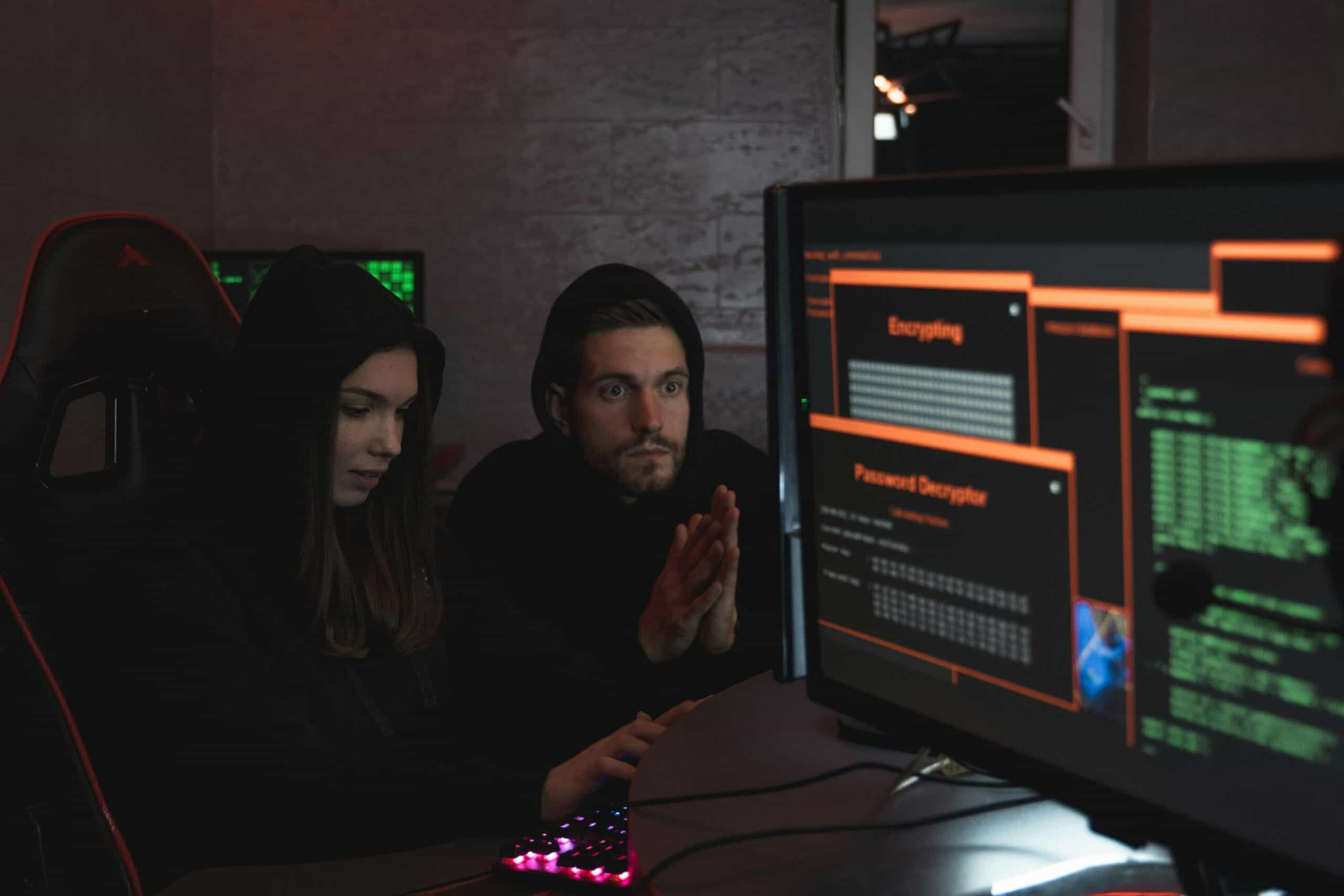 A man and woman try to hack a computer system.