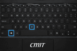 A real photograph of a laptop keyboard in close-up, shallow focus on the Windows key and the V key.