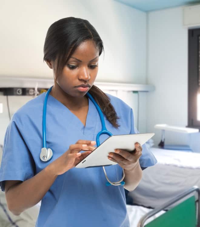 nurse observing patient files on a tablet