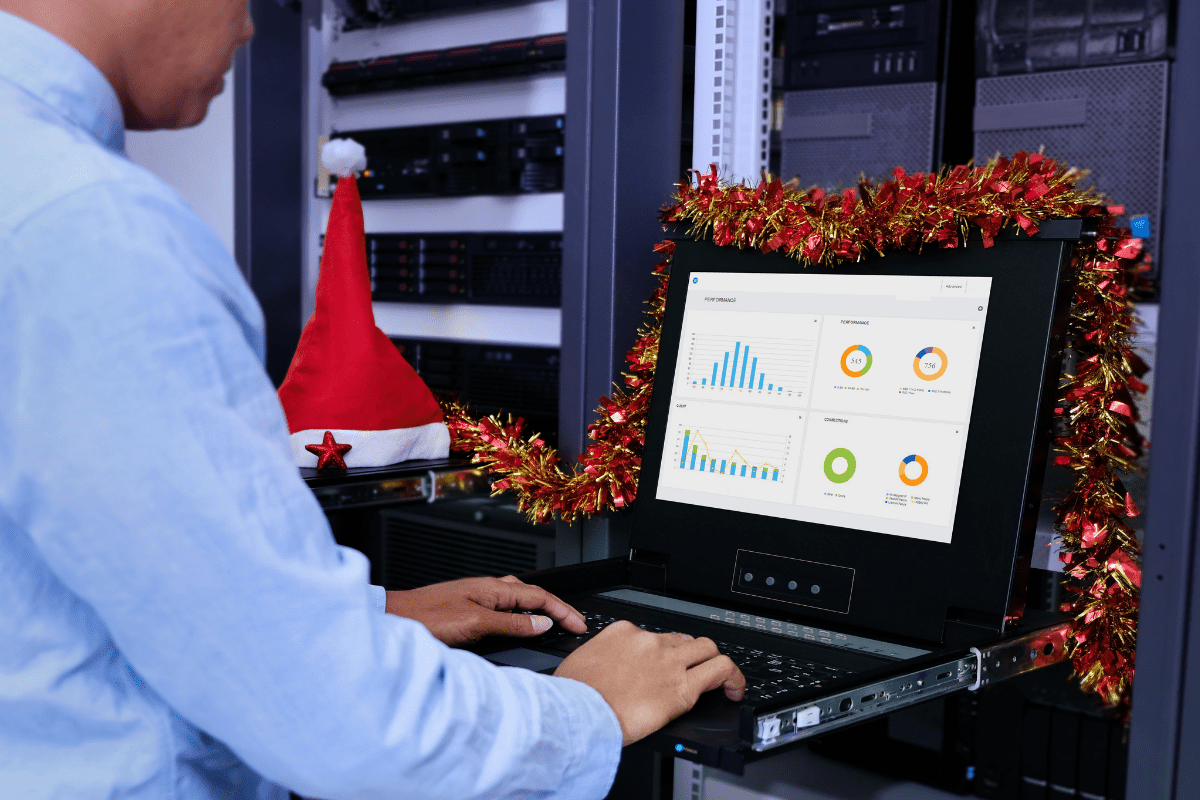 Man on laptop in server room during holidays_feature