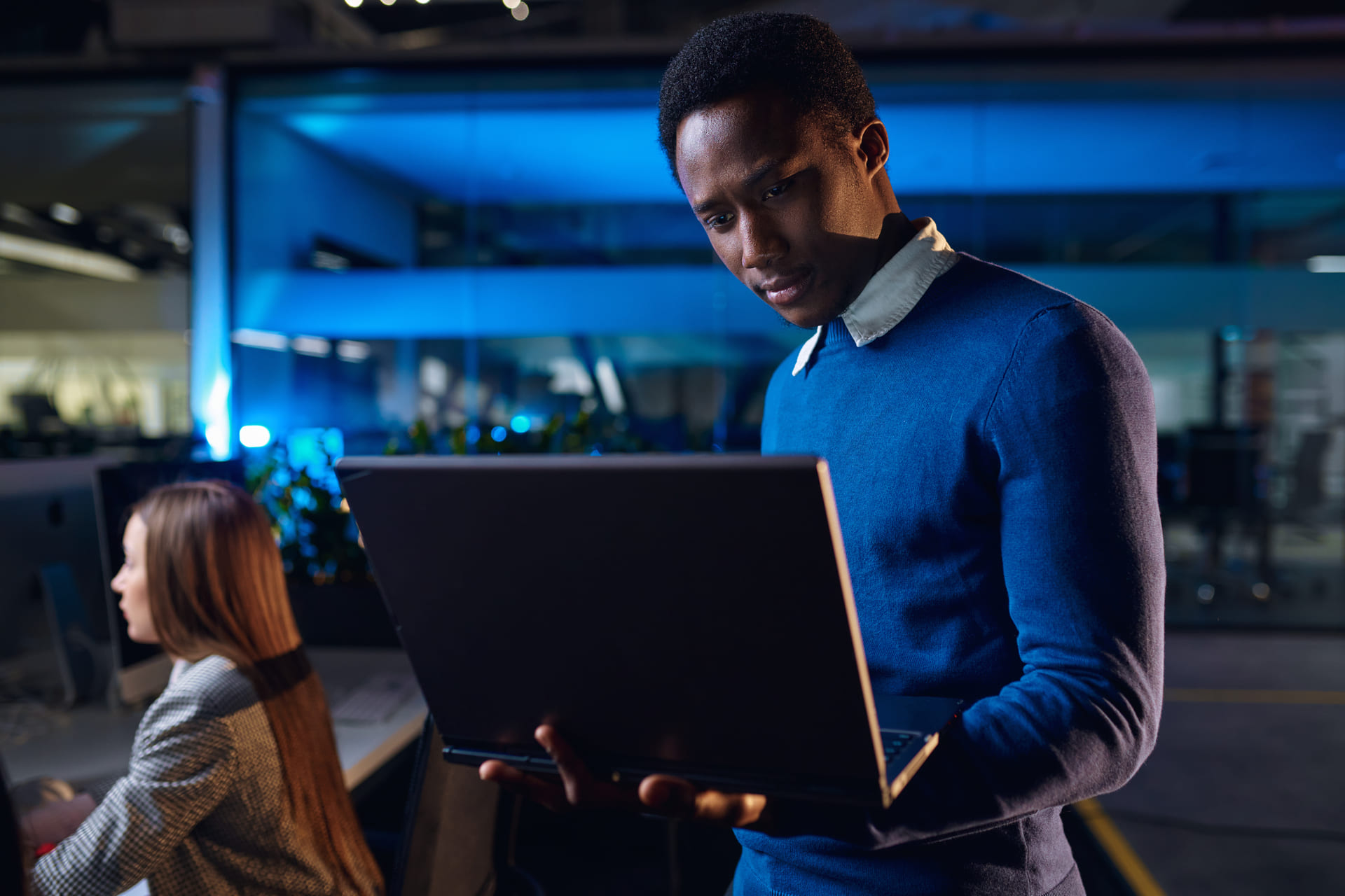 Employee working late at the office focused on a laptop screen