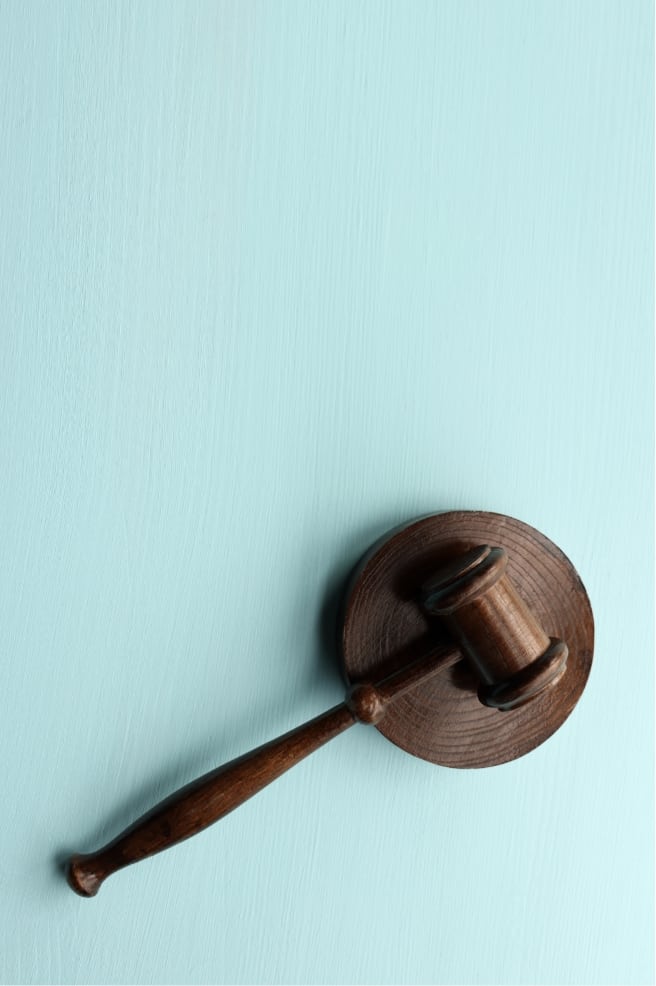 brown judge gavel with blue background