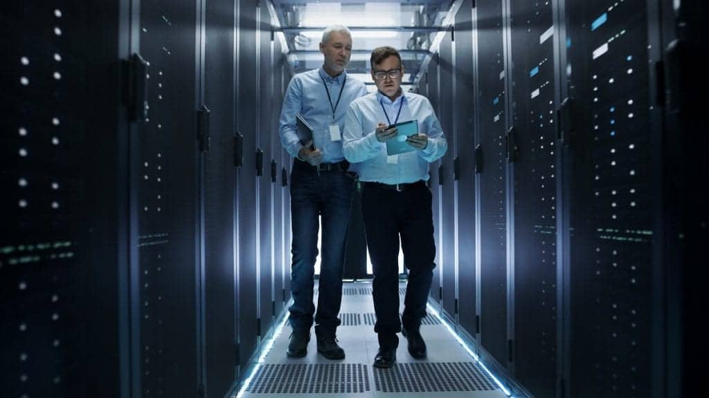 IT personnel walking inside data server