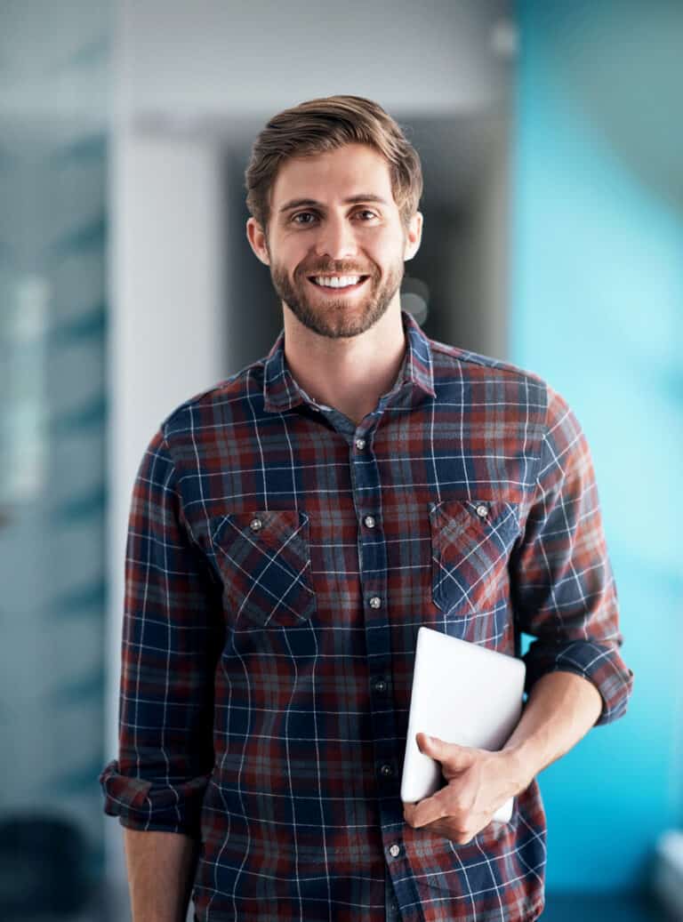 man with a beard holding a cyber secure laptop thanks to cmit solutions it services for startups