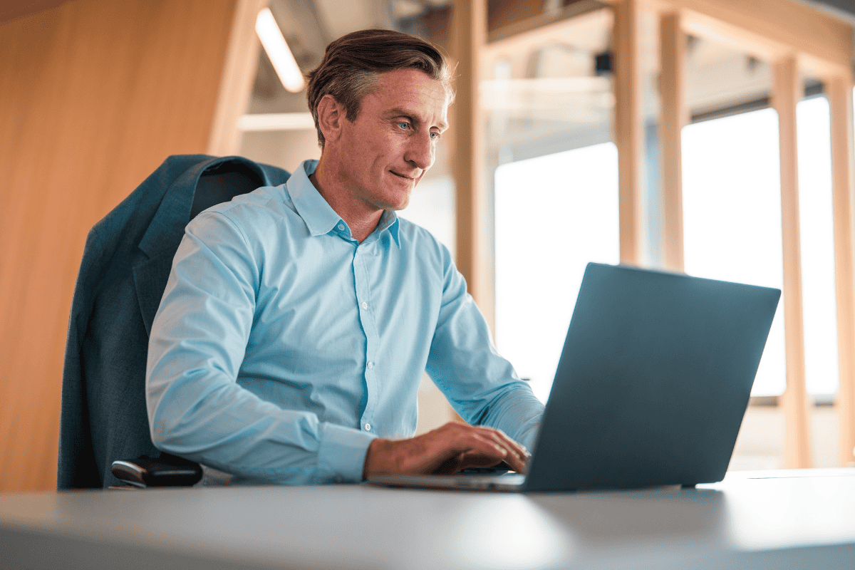 Man reading email on desktop computer.