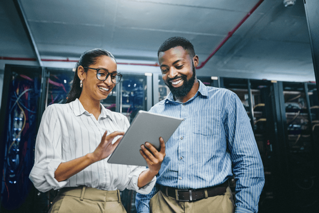 Man and woman holding tablet.