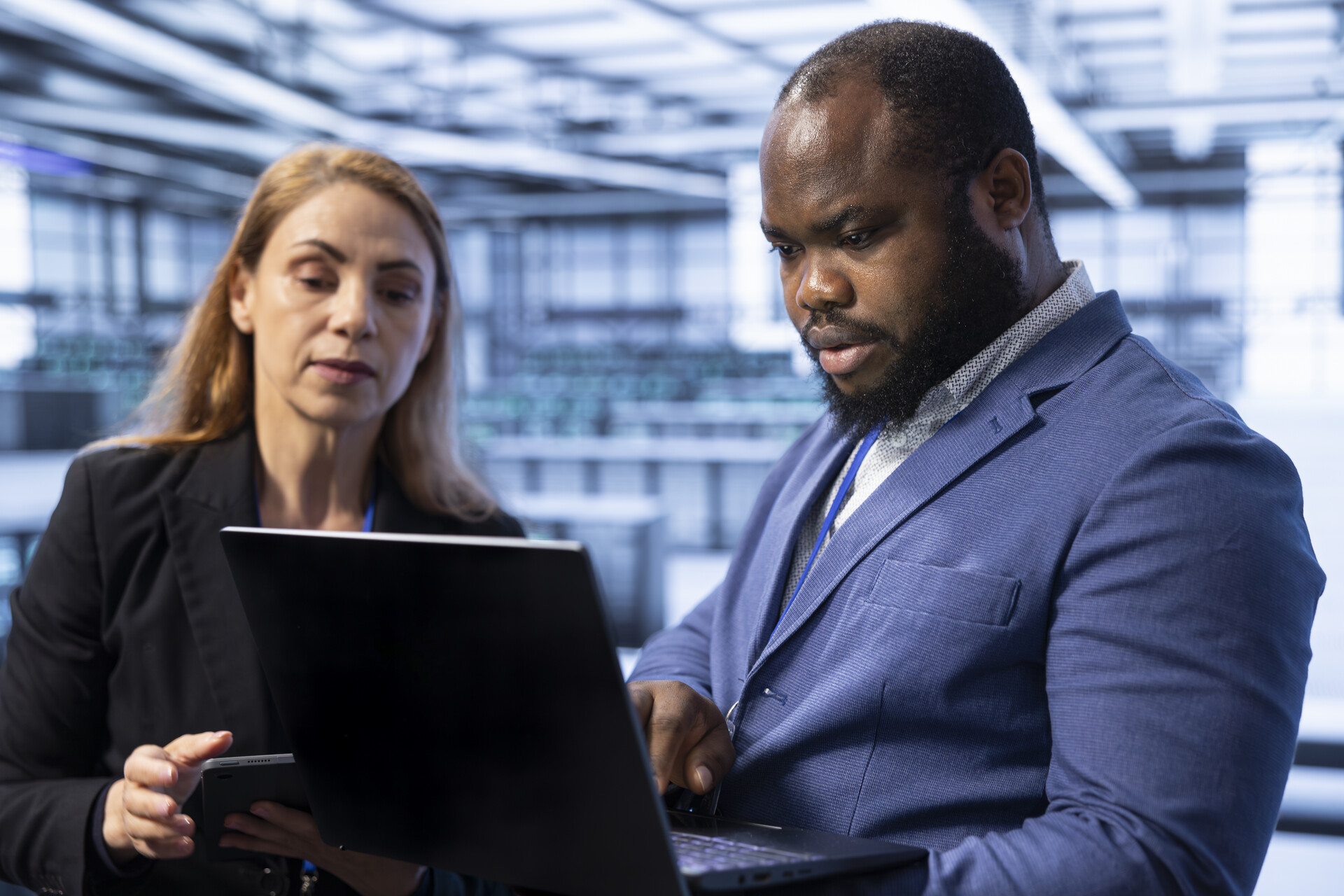data center it professionals working on laptop