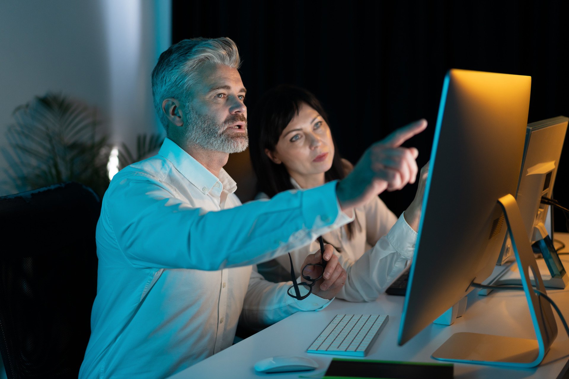 focused professionals collaborating on computer