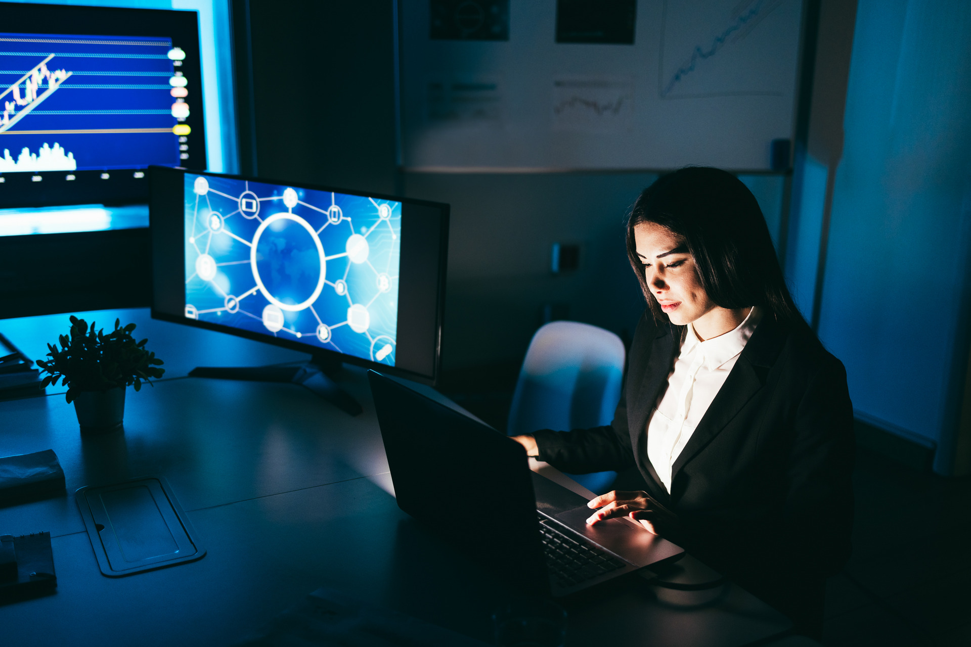 young business woman working at night inside fintech company