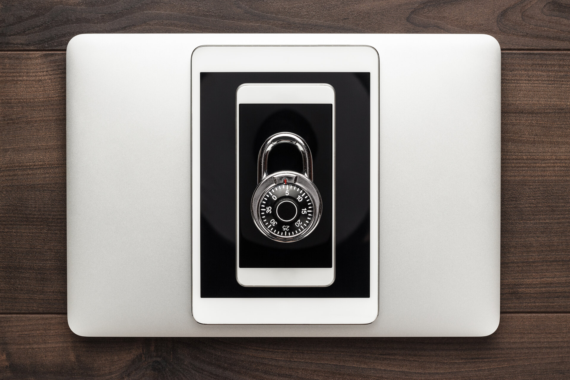 laptop tablet phone and padlock