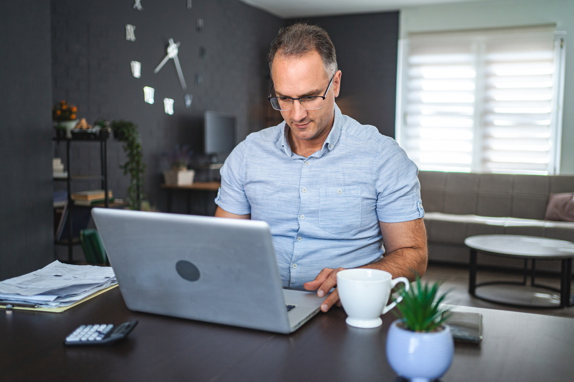 man working on laptop at home | CMIT Solutions man working on laptop at home