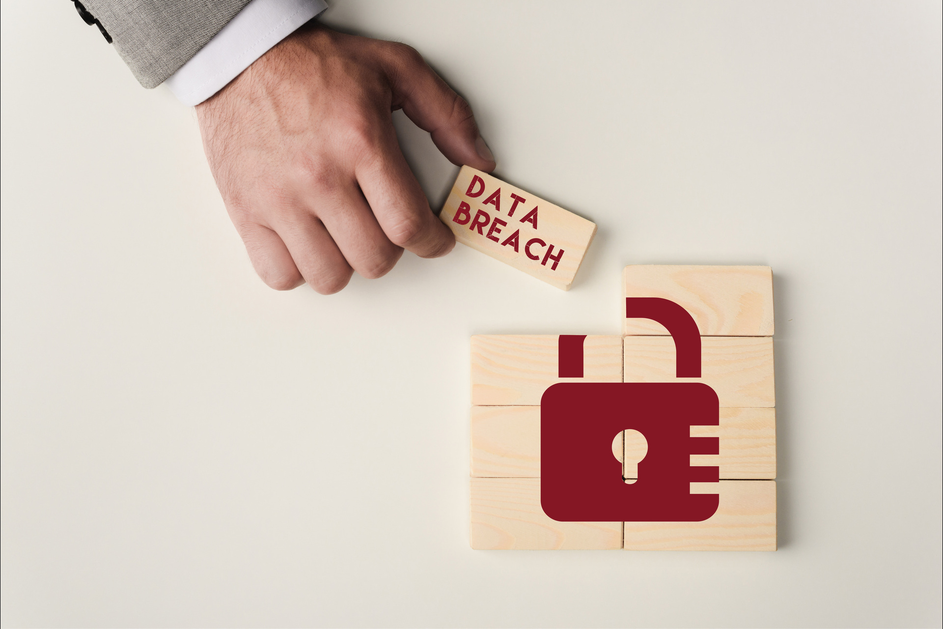 partial view of man holding brick with data breach